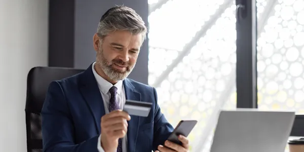 Business man using his small business credit card to make a purchase