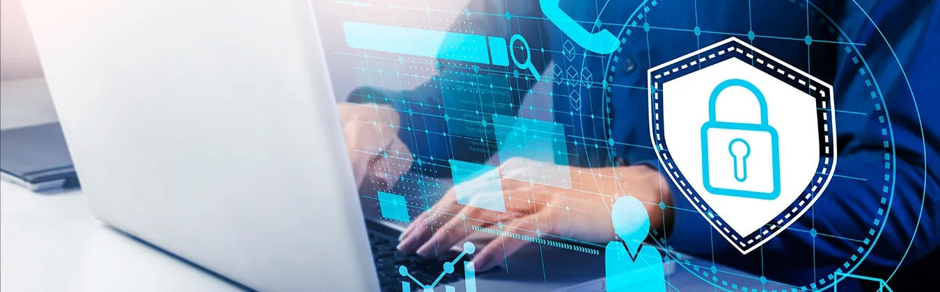 Person working on laptop with a shield graphic floating beside the laptop